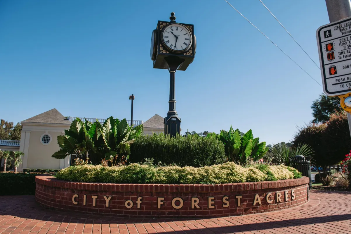 The city clock tower at the intersections of Forest Drive and Trenholm Road.